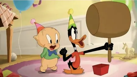 Baby Porky Pig and Baby Daffy Duck show off huge smiles as they hold a giant cartoon mallet in THE DAY THE EARTH BLEW UP: A LOONEY TUNES MOVIE, which is featured in the HBO and Max June 2025 list of new arrivals.