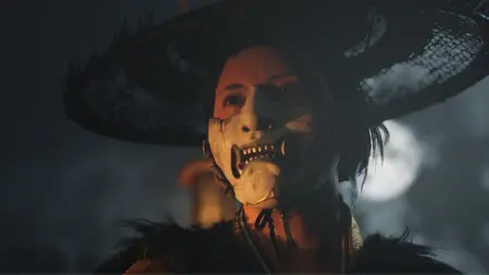 A dramatic close-up shot of the female mercenary Atsu wearing the fanged mask of the ghost in the Ghost of Yōtei video game.