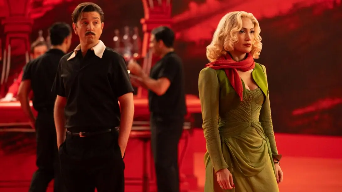 Diego Luna and Jennifer Lopez stun in Old Hollywood costumes on a vibrant red dance hall set during one of the many technicolor musical numbers of KISS OF THE SPIDER WOMAN.