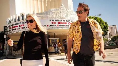 Writer-director Quentin Tarantino and actress Margot Robbie in costume as Sharon Tate walk in front of the Bruin Theater in Westwood while filming ONCE UPON A TIME IN HOLLYWOOD.