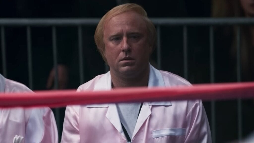 Ben Foster stars as Christy Martin's abusive husband and manager James V. Martin looking speechless from the side of the boxing ring while wearing a pink uniform in the CHRISTY biopic. 