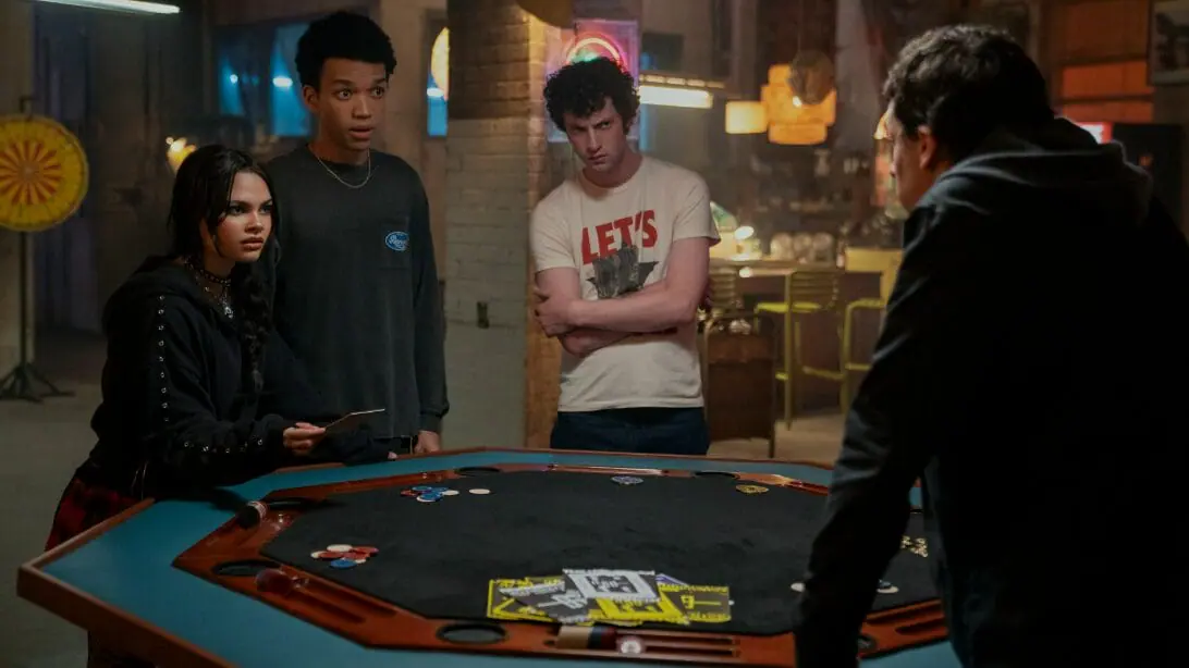 J. Daniel Atlas, played by Jesse Eisenberg, tains a young new trio of illusionists, played by Ariana Greenblatt, Justice Smith, and Dominic Sessa, in NOW YOU SEE ME 3.
