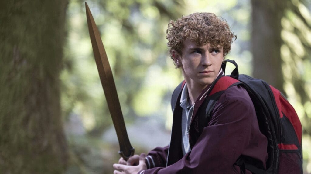 New Arrivals for Disney+ and Hulu December 2025 Walker Scobell stars as the young demigod Percy Jackson holding up a golden sword against a vibrant forest backdrop in PERCY JACKSON AND THE OLYMPIANS Season 2, which is included in the Disney+ and Hulu December 2025 list of new movies and TV shows.