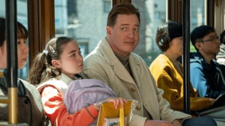 Brendan Fraser stars as American actor Phillip Vandarploeug pretending to be the father of a young girl, played by Shannon Gorman, as the two ride the train together in Tokyo, Japan in the feel-good comedy RENTAL FAMILY.