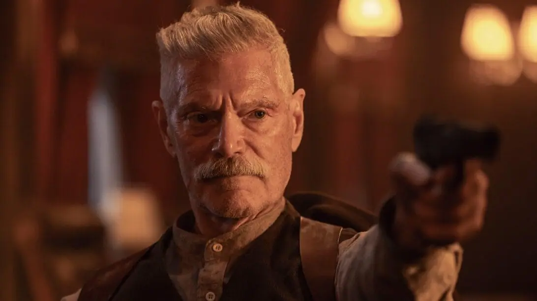 Stephen Lang stars as the villainous Soviet Red Army commander Igor Draganov holding up a gun in the action sequel SISU 2.  