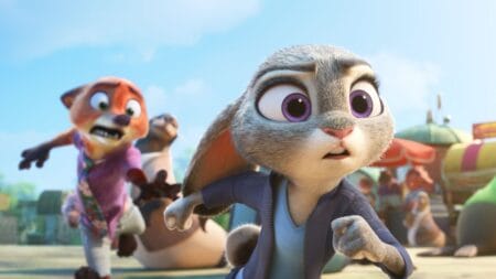 Judy Hopps the bunny chases a suspect down wooden boardwalk with her partner in crime Nick Wilde the fox hilariously trying his best to keep up with her from behind in the animated Disney sequel ZOOTOPIA 2.