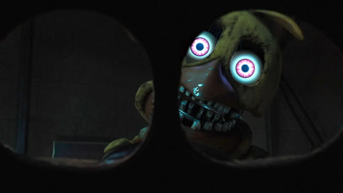 A POV shot of former security guard Mike Schmidt being confronted by the horrifying Withered Chica animatronic while wearing a fake Freddy mask in the movie sequel FIVE NIGHTS AT FREDDY'S 2. 