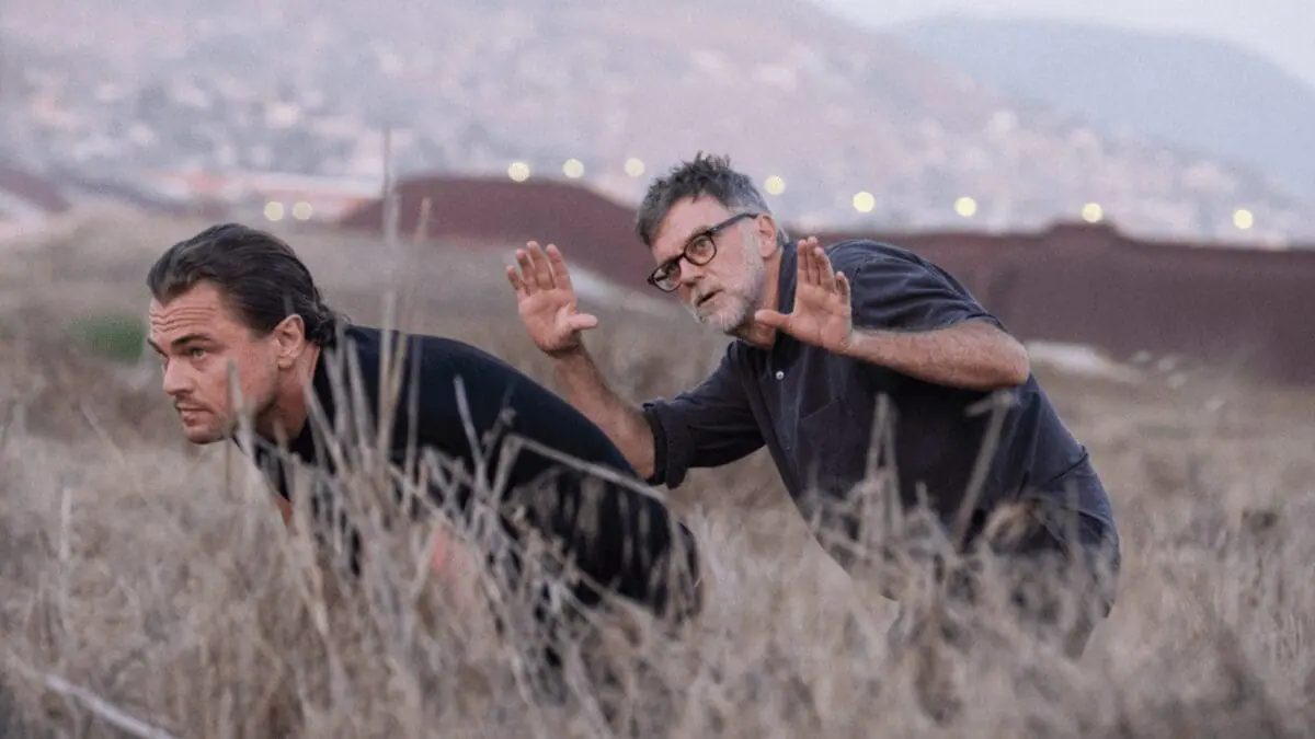 Director Paul Thomas Anderson frames a shot of actor Leonardo DiCaprio sneaking through a large dry field in his political drama ONE BATTLE AFTER ANOTHER.