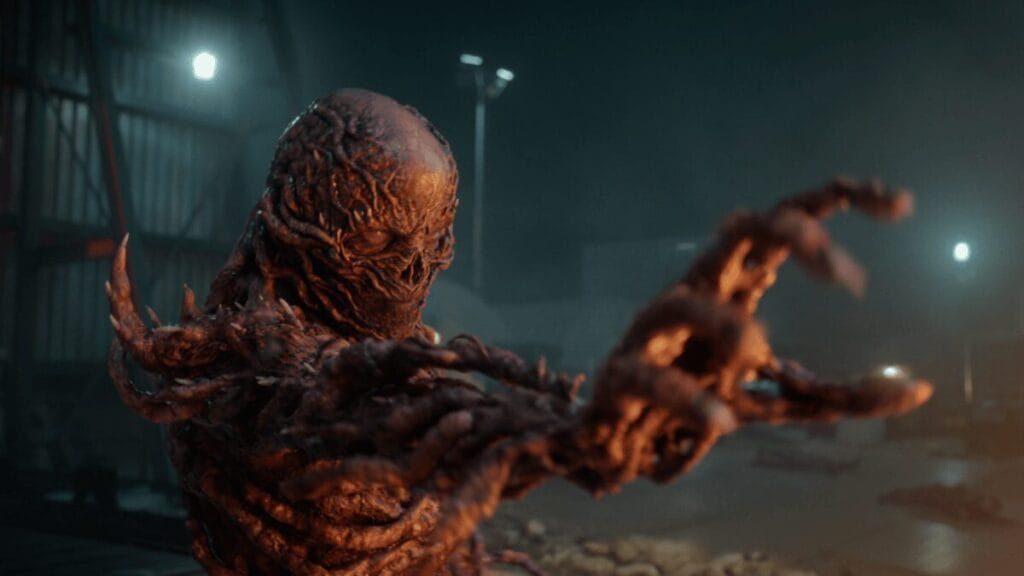 Vecna, the evil and disfigured monster who rules over the Upside Down, raises his hand to the camera as he uses his powerful telekinesis in Stranger Things Season 5. 