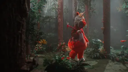 A large, fuzzy bright-orange anthropomorphic unicorn with head bandages walks through a creepy forest holding a sharp axe in the horror comedy BUDDY.