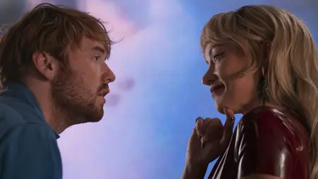 Cooper Hoffman and Olivia Wilde stare passionately into each other at a colorful art gallery in Gregg Araki's comeback film I WANT YOUR SEX.