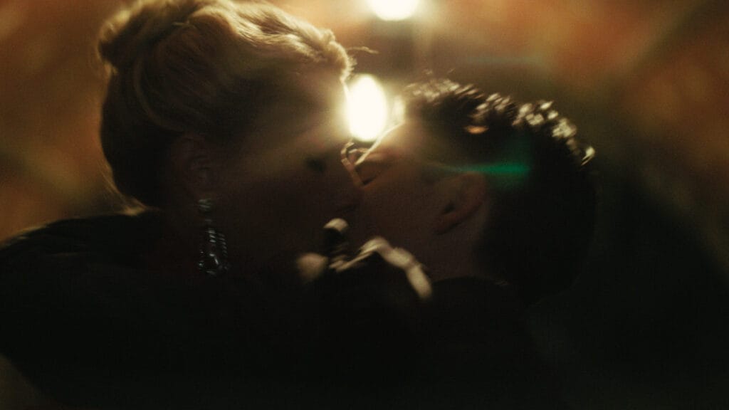 Gwyneth Paltrow and Timothée Chalamet share a romantic kiss together inside a dim tunnel in Grand Central Park in the 1950s-set sports drama MARTY SUPREME.