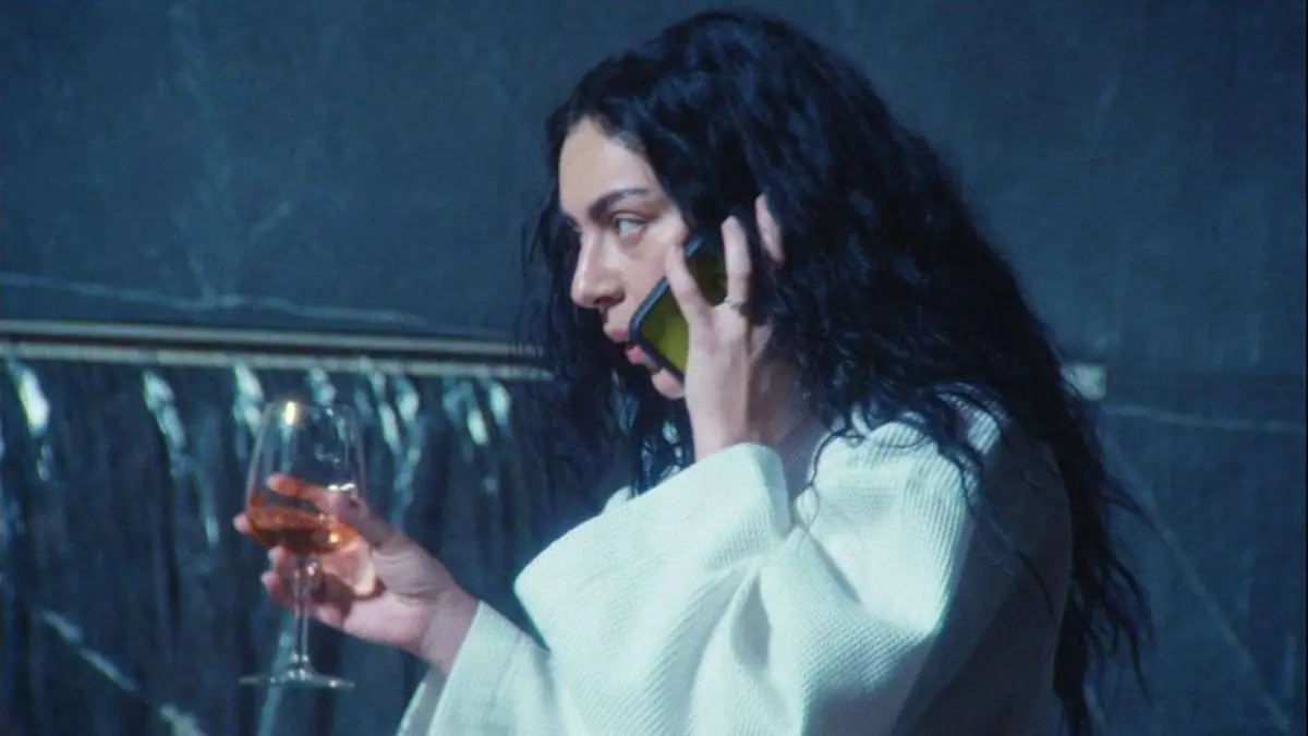 Pop star Charli xcx looks stressed while arguing on the phone with her manager at a fancy spa in her A24 film THE MOMENT. 