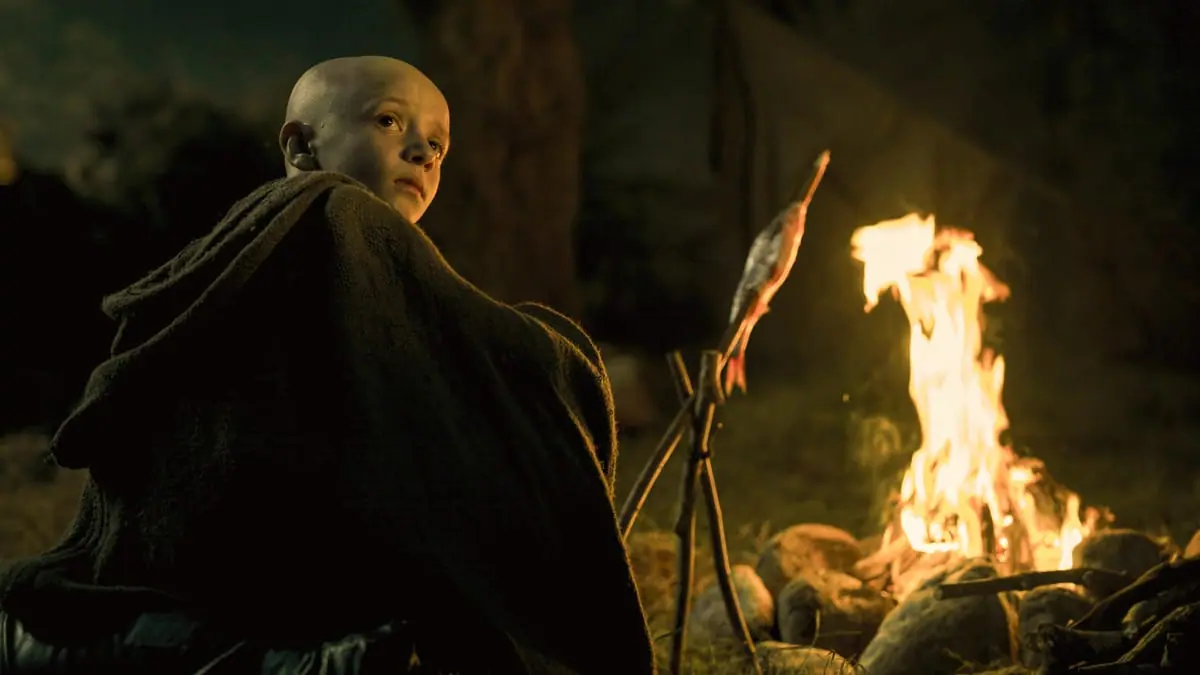 Dexter Sol Ansell stars as the young squire Aegon Targaryen, also known as Egg, sitting by a large camp fire in the Game of Thrones spin-off series A KNIGHT OF THE SEVEN KINGDOMS. 