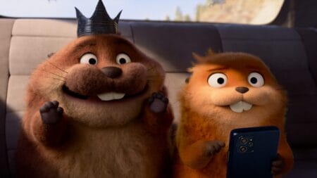 A hilarious image of King George the beaver, voiced by Bobby Moynihan, looking happy and excited as he sits next to Mabel the robot beaver, voiced by Piper Curda, while she looks terrified in Pixar's HOPPERS.
