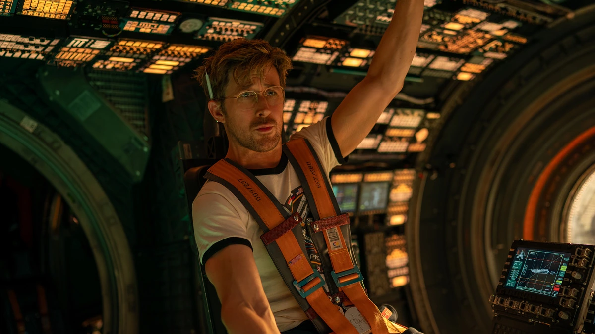 Ryan Gosling shows off his good looks while piloting a highly advanced spaceship in the sci-fi adventure movie PROJECT HAIL MARY.