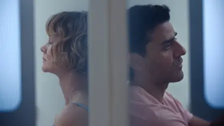 Carey Mulligan and Oscar Isaac sit down on opposite sides of a door while looking depressed and frustrated in BEEF Season 2.
