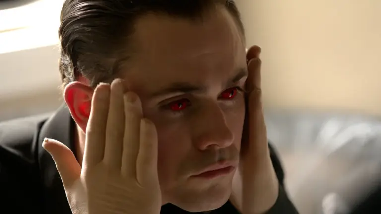 Dacre Montgomery stars as a demented serial killer wearing bright red eye contacts in the 2026 horror reimagining of FACES OF DEATH.