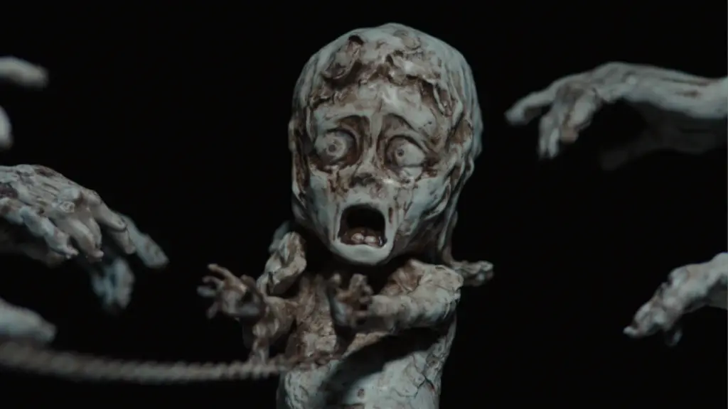 A small and very creepy rusted Irish statue of a young boy crying. 