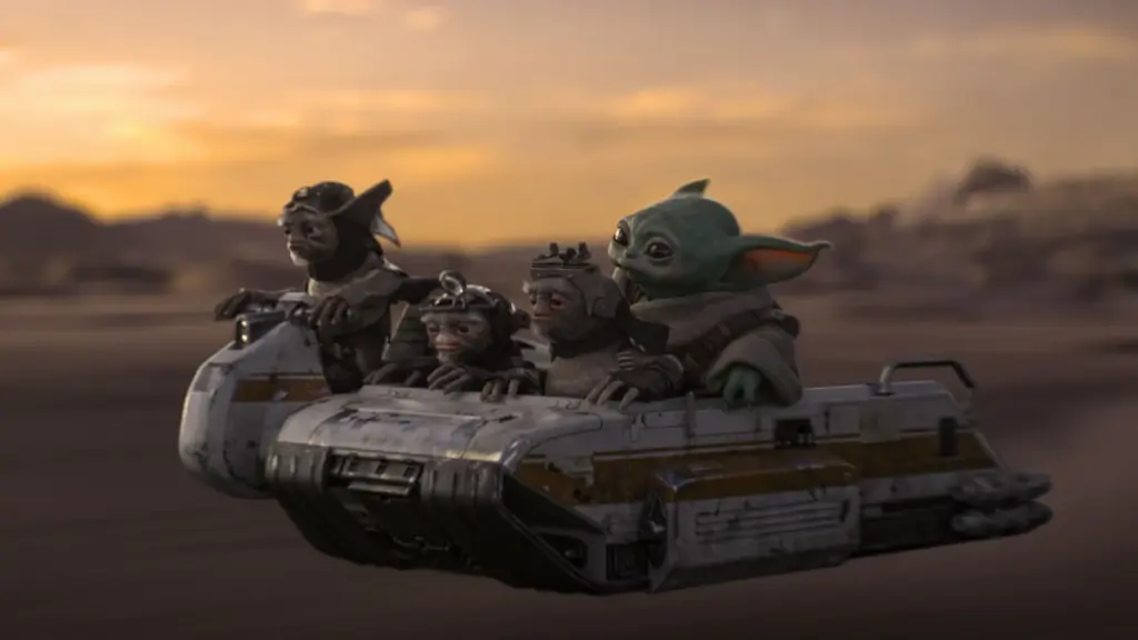 A group of three small alien Anzellan engineers take Baby Yoda on a ride on their tiny speeder across a desert sunset backdrop in THE MANDALORIAN AND GROGU.