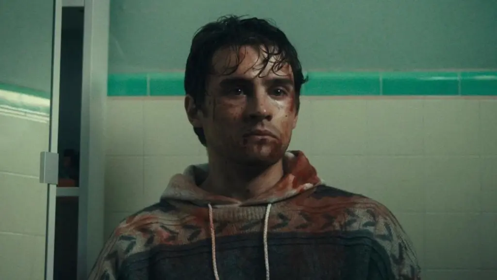Michael Johnston stars as the hopeless romantic Bear as he sits in his bathroom covered in dirt and blood with a very regretful facial expression in the cautionary horror film OBSESSION.