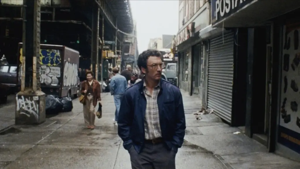 Miles Teller walks down a busy New York street as the humble family man Irwin Pearl in James Gray's Paper Tiger.  