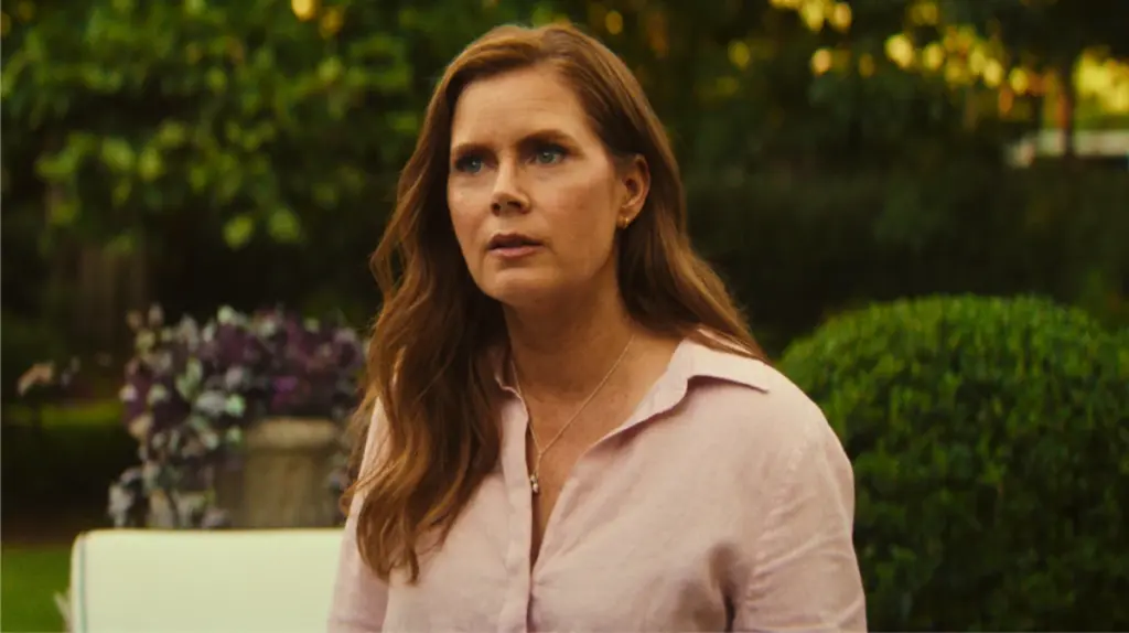 Amy Adams gives a stern facial expression as attorney Anna Bowden during a tense scene in the Apple TV+ original series adaptation of CAPE FEAR. 