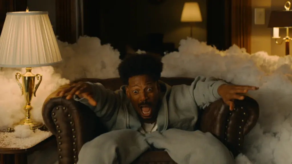 Shorty played by Marlon Wayans sinks into his chair as the horror film Get Out is parodied in Scary Movie 6. 