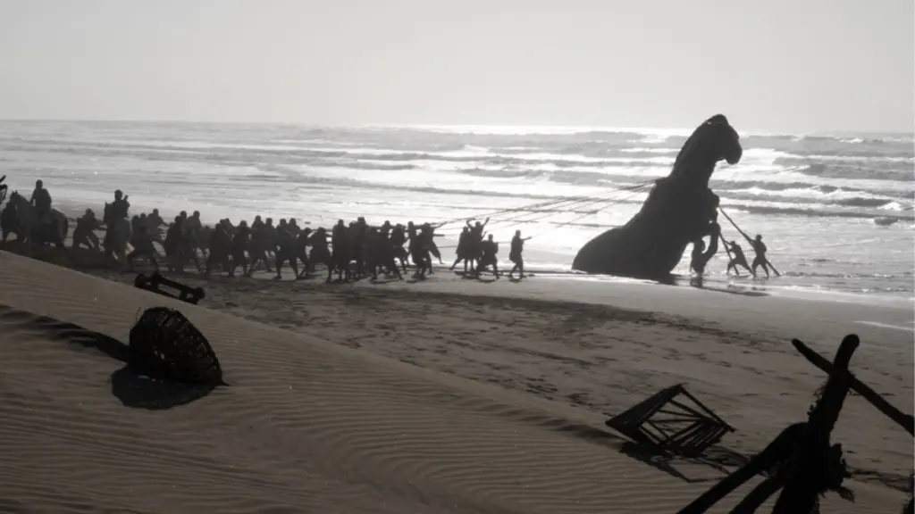 The massive 36 foot-tall Trojan Horse is lifted from a beautiful sandy beach by a large crowd of men in Christopher Nolan's THE ODYSSEY. 