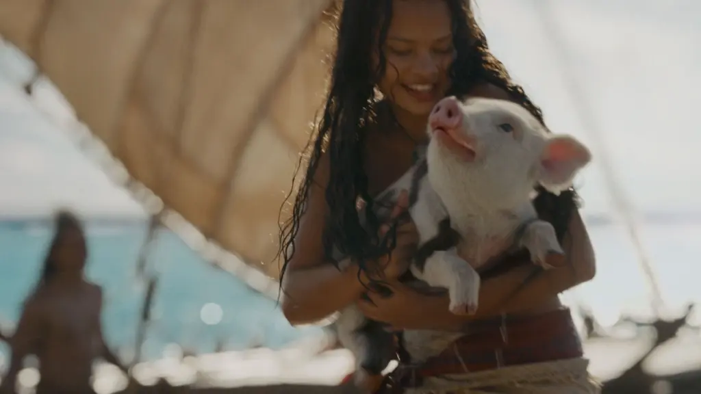 Catherine Laga'aia stars as Moana giving a big hug to her loyal pig companion Pua in the Disney live-action remake.