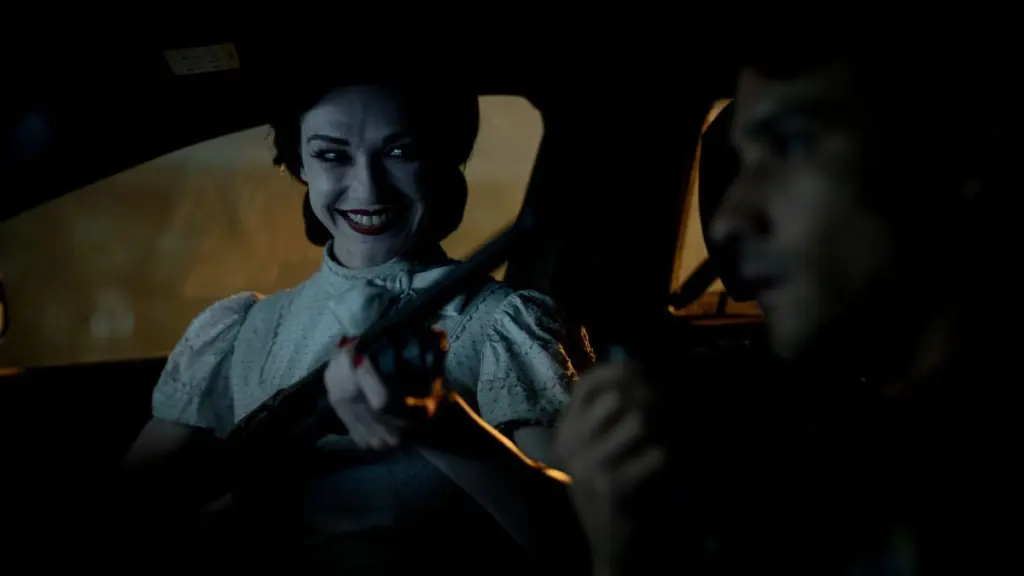 The Doll Girl ghost returns with a creepy smile and aims her shotgun in INSIDIOUS: OUT OF THE FURTHER.